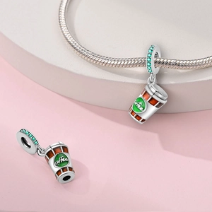 Detailansicht eines Kaffeetassen-Anhängers mit grünem Zirkonia und Kaffee-Logo für Armbänder