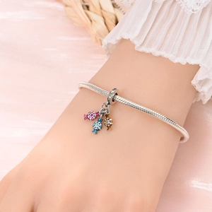 Silver snake chain bracelet with colorful candy pendants and sparkling stones detail