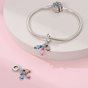 Detailed view of silver snake chain bracelet with colorful enamel candy charms and flowers