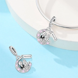 Detailed view of silver moon charm with wedding couple design and sparkling zircon stones