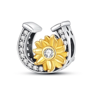 Detailed view of horseshoe and sunflower charm with zircon pavé and heart cut-outs