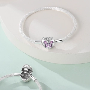 Macro view of S925 sterling silver heart clasp featuring purple butterfly and floral motifs