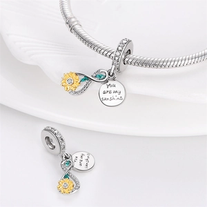 Macro view of sunflower infinity charm with You are my sunshine engraving for bracelet