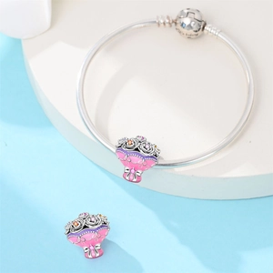 Macro detail of silver snake chain bracelet with purple enamel bouquet floral charms