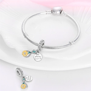 Detail of sunflower charm with infinite symbol and You Are My Sunshine engraving on bracelet