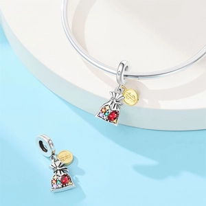 Macro detail of money bag charm with colorful zircons and golden dollar sign pendant