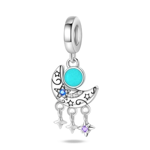 Detailed close-up of a silver moon charm with turquoise stone and celestial stars