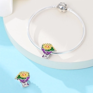 Detailed view of sunflower bouquet charms with colorful enamel on a silver bracelet