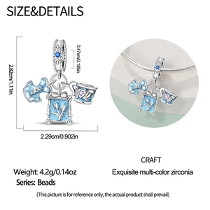 Detailed view of silver charm with blue dress, tulip frame, and teacup for bracelets