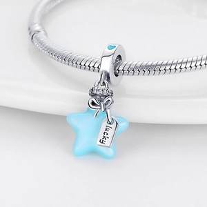 Macro shot of a blue star pendant with lucky charm on silver snake chain bracelet