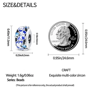 Blue enamel butterfly bead with zircon detail shown next to a coin for scale
