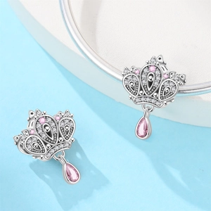 Detail of silver crown charm with pink pear-shaped stone and white zircon pavé setting