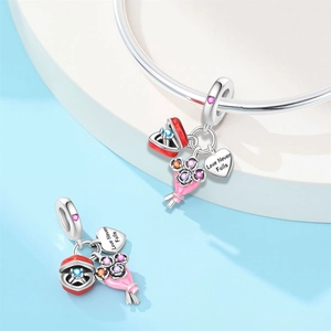 Detailed shot of silver charms featuring flower bouquet and Love Never Fails engraving