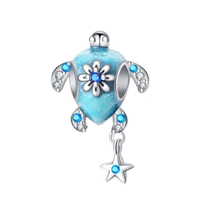 Silver sea turtle charm with blue enamel shell, flower detail and starfish pendant