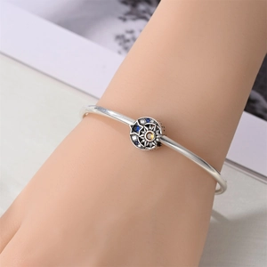 Close-up of celestial sun and moon charm bracelet with multi-color zircon inlay