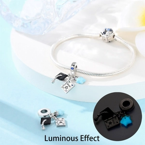 Detailed macro view of S925 silver graduation charm bracelet with luminous blue star