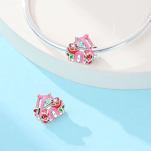 Detail of pink house charm with red roses on silver bracelet for romantic jewelry DIY