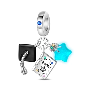 Detailed view of graduation charm with mortarboard, book, and luminous star pendant