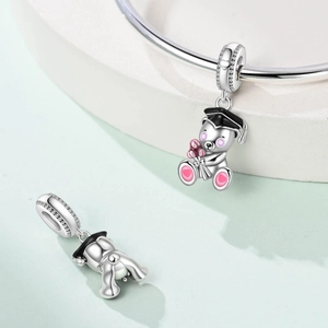 Silver graduation bear charm with black cap and pink flowers on a bracelet detail