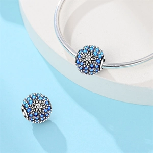 Detailed view of blue zircon star charms on a silver bracelet with celestial bead design