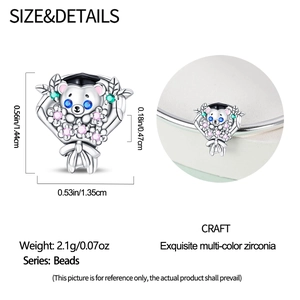 Macro detail of graduation bear charm with colorful cubic zirconia and hat