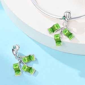 Macro detail of a 100 dollar bill charm in green enamel and silver for DIY bracelets