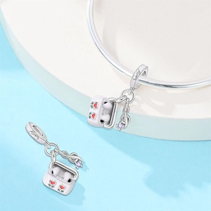 Close-up of silver beaded headphone charm with red hearts and purple gem musical note