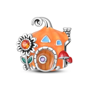 Detailed view of an orange enamel pumpkin house charm with colorful zircon stones