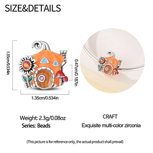 Detail of enamel pumpkin house charm with colorful zircons and size specifications