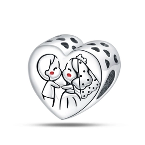 Detail of silver heart charm featuring a cartoon bride and groom kissing with hollow heart sides