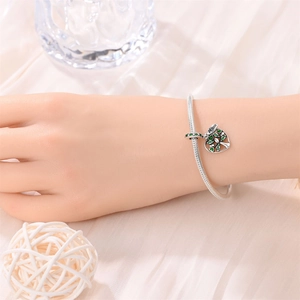 Detail of silver snake chain bracelet with green Tree of Life charm and Mom engraving