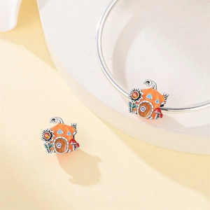 Macro shot of silver pumpkin house charm with enamel maple leaves and sunflower details