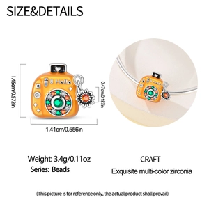 Detail of camera charm with orange enamel and colorful zirconia, 1.41x1.45cm size