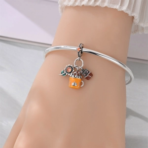 Silver charm bracelet with enamel pumpkin, sunflower, and chocolate bar pendants