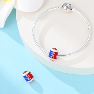 Silver snake chain bracelet featuring American football charms with red blue enamel star detail