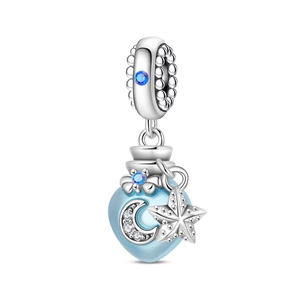 Macro detail of silver lobster charm with blue heart vial and crescent moon star