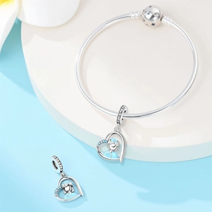 Detail of silver nurse heart charms with blue enamel and crystal on a bangle bracelet