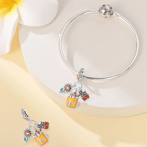 Detail of S925 silver bangle with sunflower, pumpkin spice mug and chocolate autumn charms