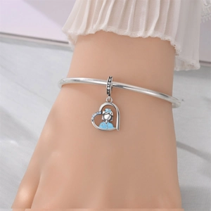 Detail of silver heart nurse charm bracelet with blue enamel and zircon inlay