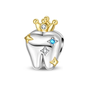 Close-up of silver tooth charm with gold crown and blue zircon stone for DIY jewelry