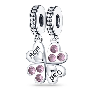 Detailed view of silver heart charms with Mom and Dad engraving and pink gemstones