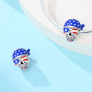 Detailed view of patriotic skull charms with US flag patterns on a silver bracelet