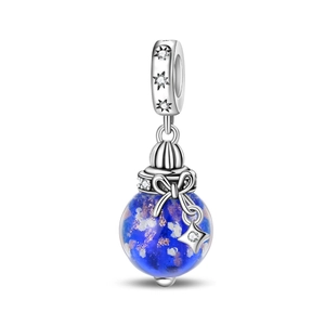 Detail of silver blue glass charm with glittering stardust effect and star pendant