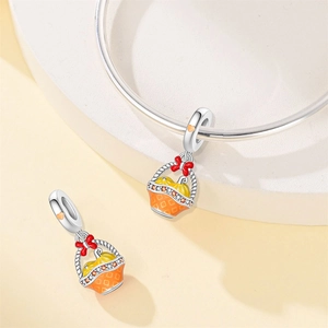 Detailed close-up of a pumpkin basket pendant charm with orange enamel and zircon accents