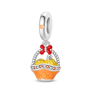 Detailed pumpkin basket charm with orange enamel, autumn acorns, and red ribbon bow