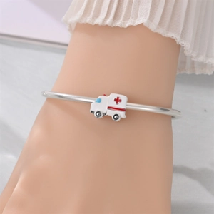 Detail of silver ambulance charm with red cross and enamel finish on a bead bracelet