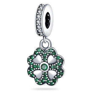 Close-up of silver four-leaf clover charm with green gemstones and pavé crystals
