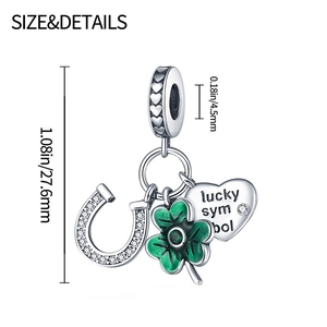 Macro detail of lucky horseshoe and green enamel clover charms on silver bead