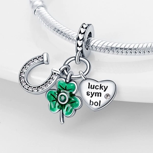 Silver lucky charm set with green clover, horseshoe, and heart on snake chain bracelet