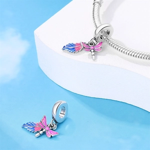 Detail of dragonfly and feather charm with blue enamel for silver snake bracelets